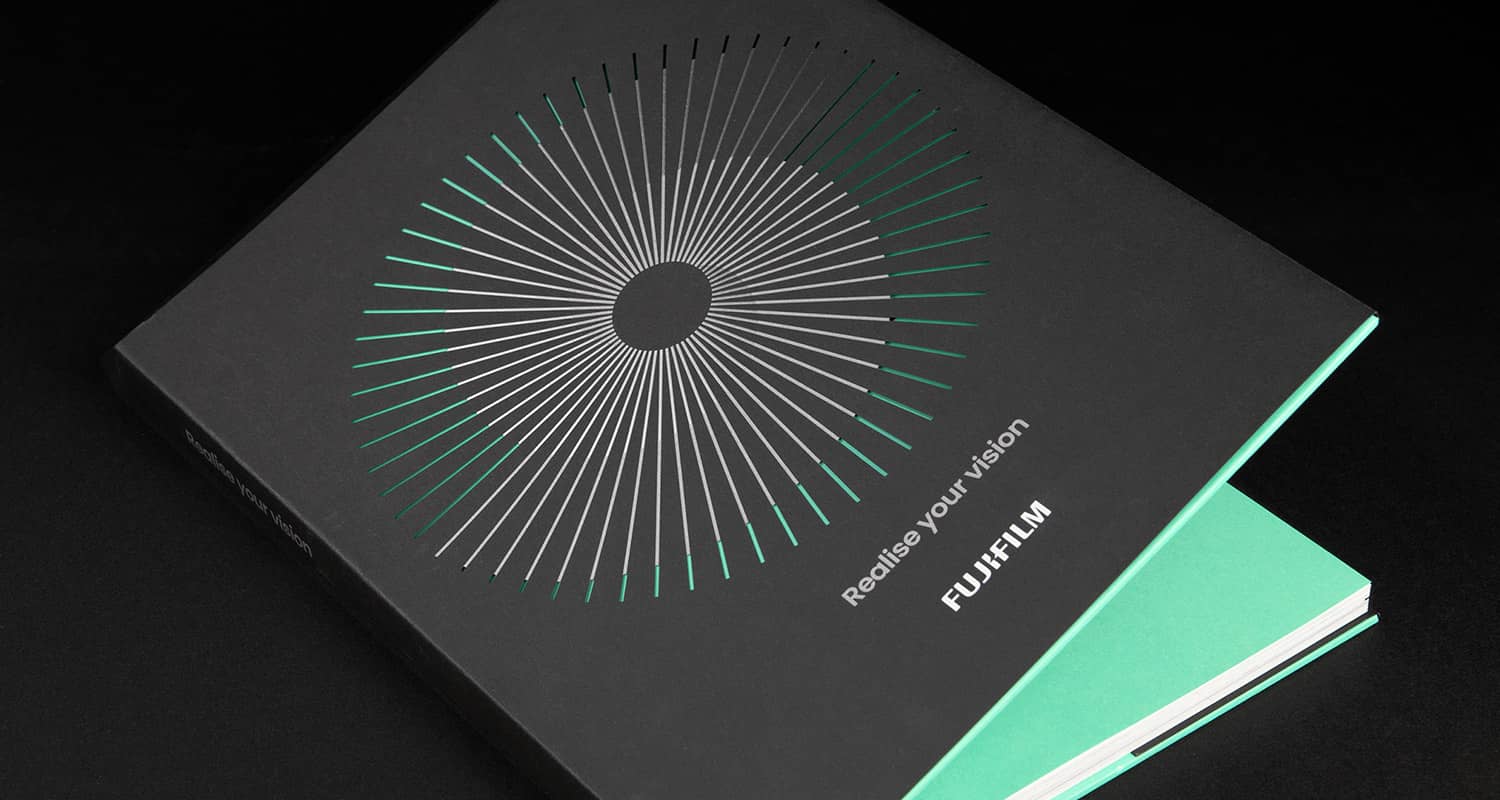 A photograph showing the cover of the Fujifilm Realise Your Vision book